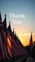 Sunset view of American flags with a message of gratitude at a memorial site photo