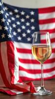 Celebrating patriotism with a glass of wine in front of the American flag photo