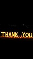 Thank you display with glowing letters and candles at night in a festive atmosphere photo