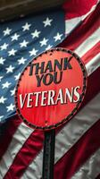 Sign displaying gratitude for veterans against a backdrop of the American flag photo