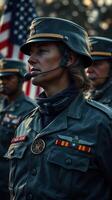 Military personnel in uniforms stand in formation during a ceremonial event with flags displayed in the background photo