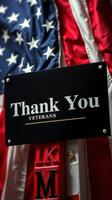Recognition for veterans with a thank you sign displayed alongside an American flag photo