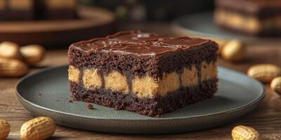 Indulge in rich chocolate and peanut butter layered dessert on a wooden table with peanuts photo