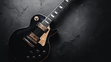 Black electric guitar resting on a textured dark surface with intricate details and elegant design features photo