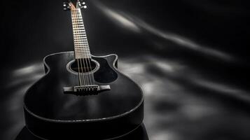 Elegant black acoustic guitar on a dark backdrop with soft lighting highlighting its features and craftsmanship photo