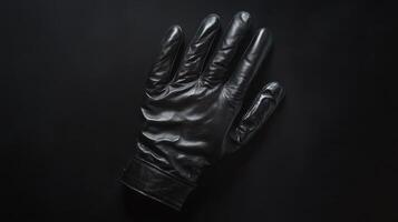 Black leather glove placed on a dark background with a sleek and modern appearance for a sense of intrigue photo