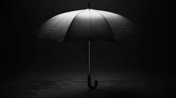 Dark and elegant black umbrella resting on wet surface with droplets reflecting subtle light photo