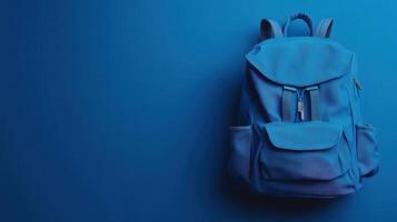 Bright blue backpack displayed against a solid blue background in a minimaliste setting for emphasizing color and design photo