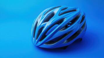 Bright blue cycling helmet on a solid blue background showcasing design and safety features photo