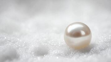A pearl is sitting on top of snow photo