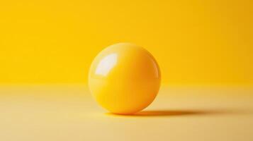 A yellow egg on a yellow background photo