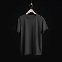 Black TShirt Hanging on Wooden Hanger Against Dark Background photo