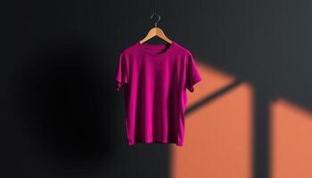 A Pink T-Shirt Hanging on a Wooden Hanger in a Studio photo