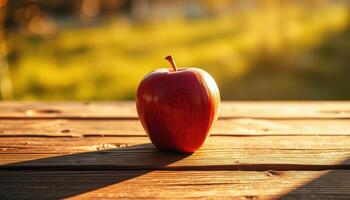 Red Apple on Wooden Table in Golden Sunlight photo