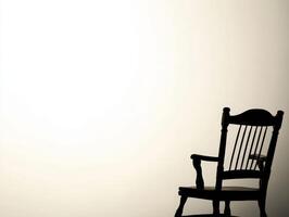 A solitary rocking chair against a pale background. photo