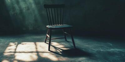 A Single Chair in a Dark Room. photo