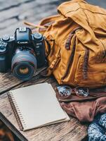 Camera, Backpack, and Notebook Preparing for a Journey. photo