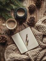 Cozy Winter Scene with Coffee, Notebook, and Pine Cones. photo