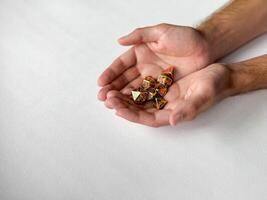 Hands presenting colorful rpg dice set on white background photo
