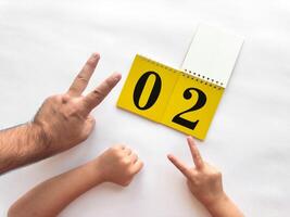 Creative countdown with hands and calendar on white background photo