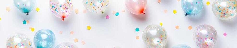 Festive overhead flat lay of clear balloons with colorful confetti for celebrations and party designs photo