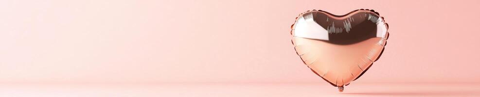 Metallic rose heart balloon on soft pink background for romantic celebrations and event decor photo