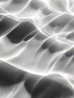 Monochromatic close up of rippled sand dunes highlighting natures patterns and texture photo