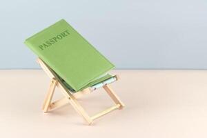Passport and chaise lounge on a light background. photo