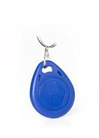Blue RFID key fob with a metallic keyring, isolated on a white background. secure access systems photo