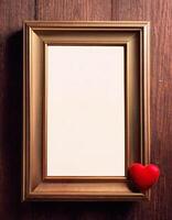 Blank vintage photo frame mockup with heart decoration. Elegant ornate frame with red heart on rustic wooden table background for presentation and display love-themed projects.