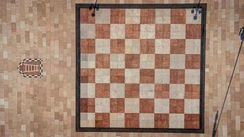 Large chessboard seen from above. Chess square in the center of Marostica, a medieval town in Italy. Texture and background of chessboard squares photo