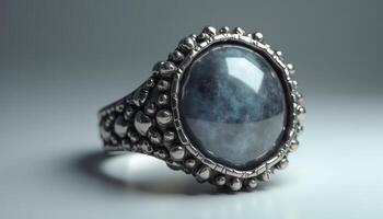 Intricate silver ring featuring a mesmerizing blue stone under soft light photo