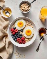 Fresh Breakfast Bowl with Eggs, Berries, and Oats on Table photo