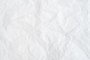 Wrinkled or crumpled white paper texture used as crumpled white paper background texture in decorative art work photo