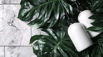 two bottles of lotion on a marble counter with green leaves photo