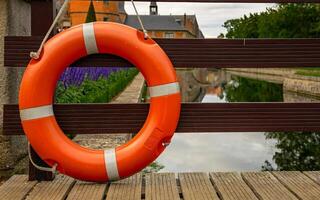 Lifebuoy on a wooden bridge near the river photo