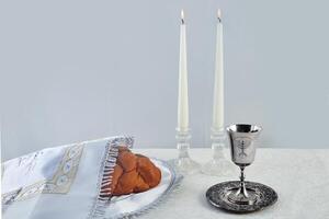 Sabbath Table Setting. Challah bread, candles, and a kiddush cup photo