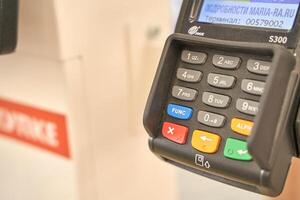 BARNAIL, ALTAI REGIOJN, RUSSIA - August 4, 2021. Credit card payment terminal close up with number keypad displaying transaction details at checkout counter. photo