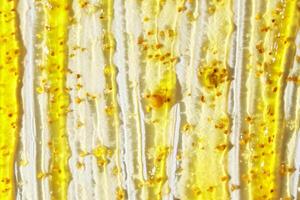Close up of yellow and white abstract texture with paint drips and bubbles. photo