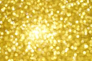 Bright golden bokeh background with soft, blurred light spots creating a warm, glowing atmosphere. photo