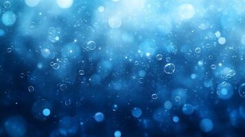 Abstract blue background with bokeh lights and bubbles. photo