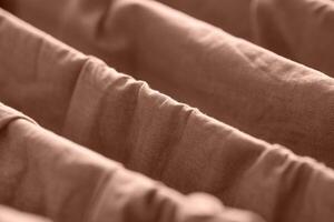 Close up of brown fabric folds with soft texture and diagonal patterns in a warm tone. photo