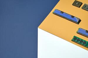 Modern computer components displayed on geometric background with ram and microchips. photo