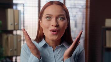 Portrait in company office amazed wonder oh my god reaction stunned big eyes open mouth shock surprise excited face student girl business woman headshot looking at camera businesswoman female lady wow video