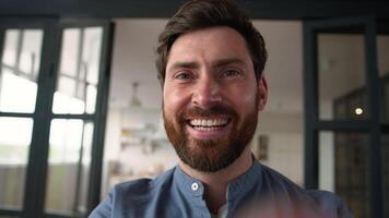 Happy Caucasian man father typing mobile phone smartphone display dad guy smiling browsing net parent using device cyberspace AR touchscreen glad male chatting online at home internet app POV webcam video