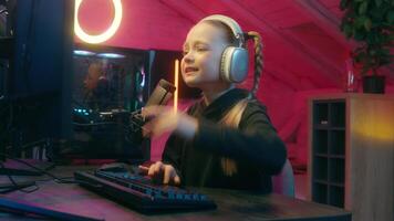 Emotional little girl gamer difficult hard streaming typing keyboard lost failure daughter kid child teen playing computer virtual game at home upset take off headphones sad suffer disappointed video