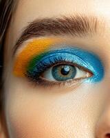 Close up of a womans eye with colorful eyeshadow photo