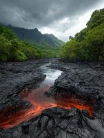Lava flow in a riverbed surrounded by lush green vegetation and dramatic mountains photo