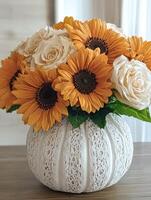 Sunflowers and roses in a lace pumpkin vase photo