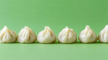 Delicate Steamed Dumplings on a Vibrant Green Background photo